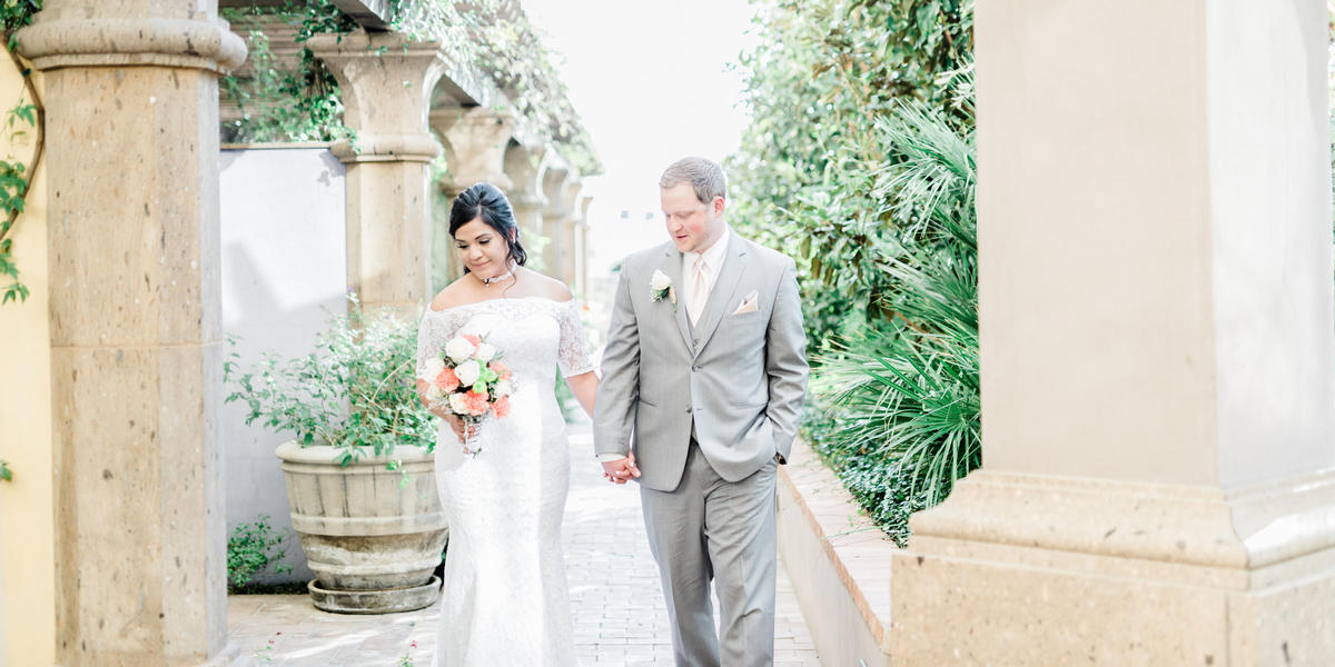 Bridal couple walking hand in hand at Hotel Encanto