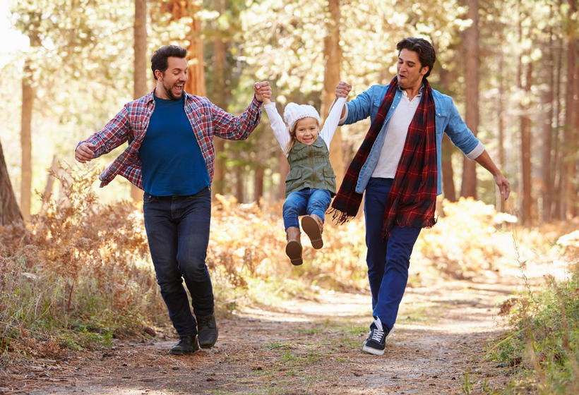 Couple and child walking through woods